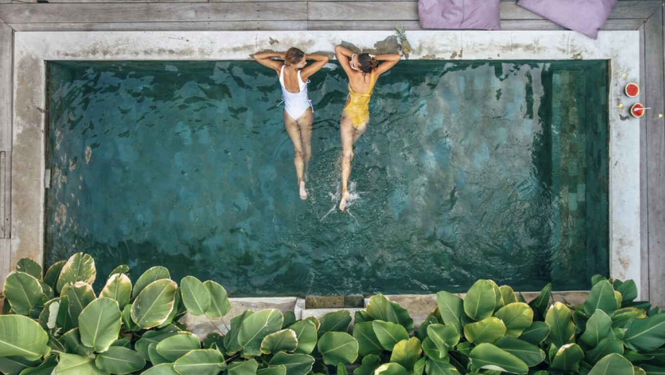 Two people relaxing in a clean, well-maintained pool in Placentia, CA